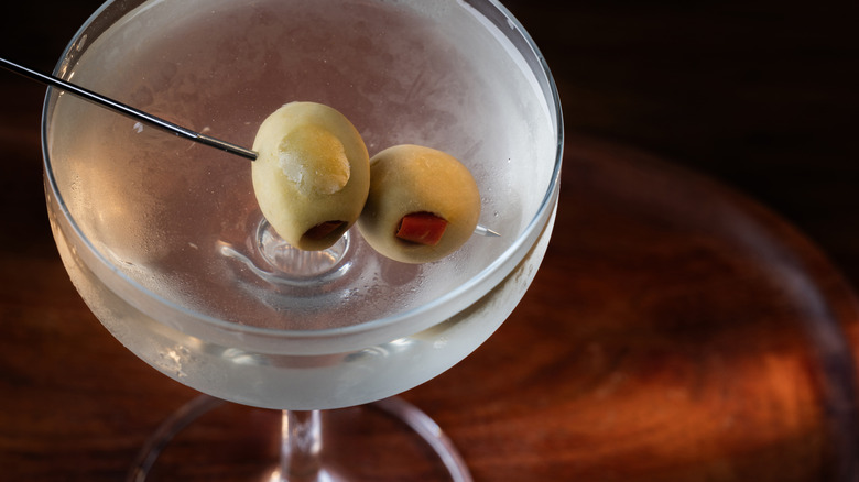 Top view of a martini in a coupe glass garnished with two olives