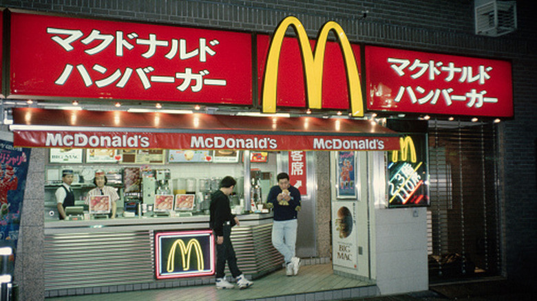 people eat outside McDonald's location in Tokyo, Japan