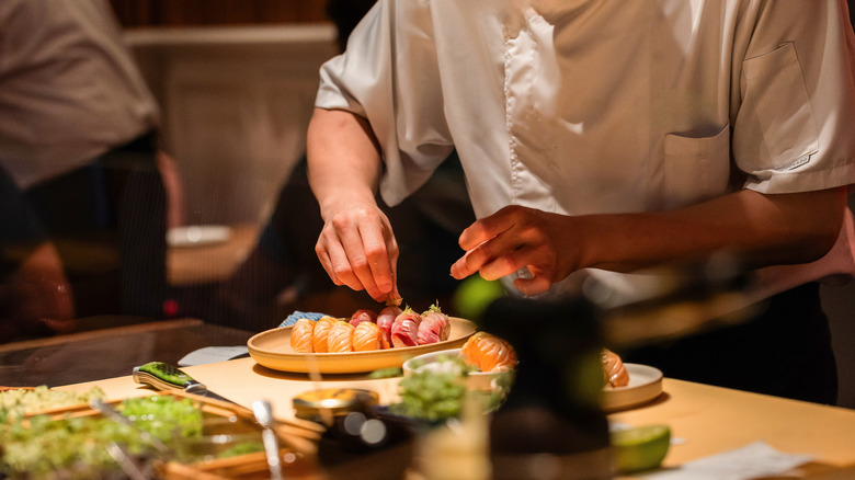 Chef making sushi at counter