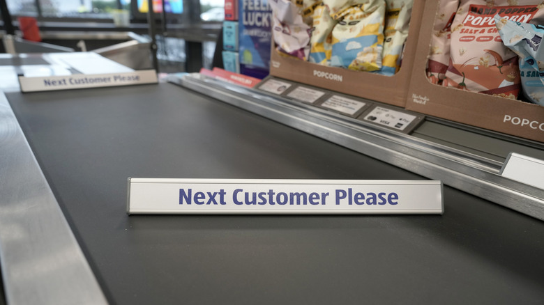 Aldi "Next Customer Please" divider on the check-out belt