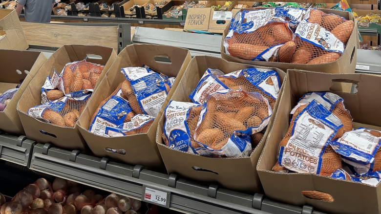 Aldi's produce aisle showing bags of potatoes