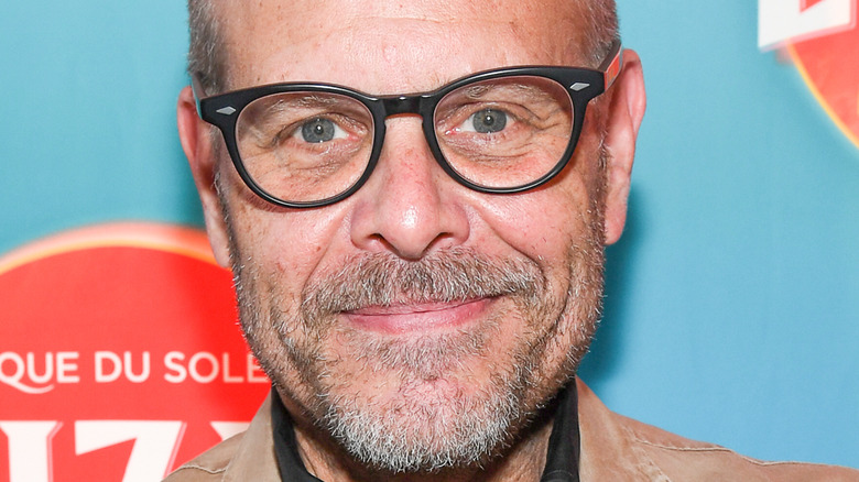 Chef Alton Brown smiles with glasses