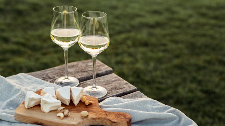 wine glasses on table with cheese