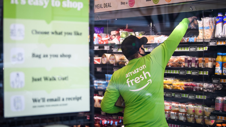 A worker stocking shelves at an Amazon Fresh location