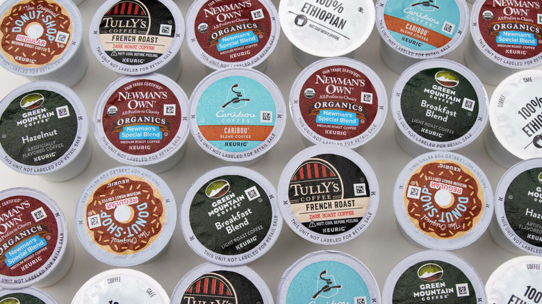 many different types of Keurig pods arrayed on a white surface