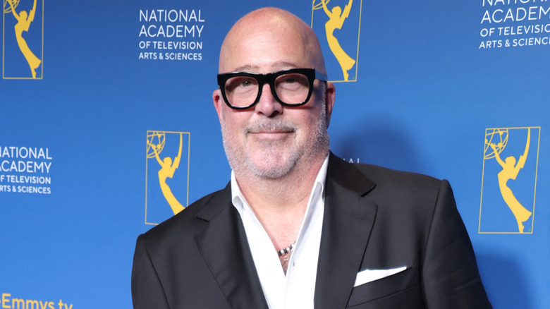 Andrew Zimmern in black suit