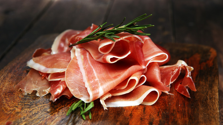 Parma ham on cutting board rosemary