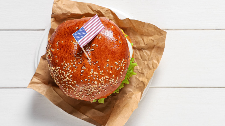 Burger skewered with an American flag toothpick