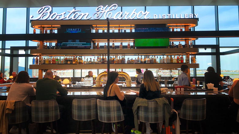 Travelers at an airport bar in Boston