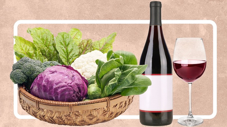A basket of cruciferous vegetables, a bottle of wine, and a glass of red wine