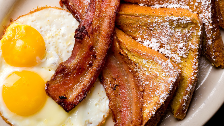 Bacon on top of french toast and eggs