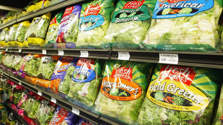 A display of Fresh Express brand bagged salads at a grocery store