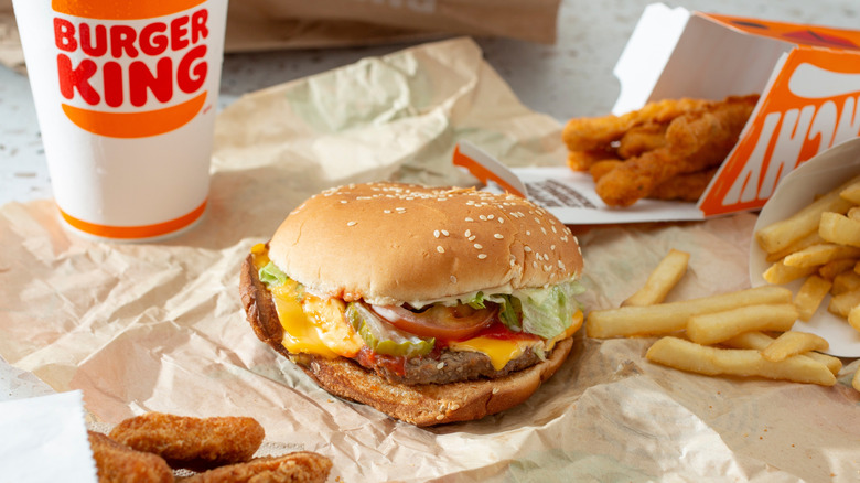 Burger King burger, drink, fries, and chicken fries laid out on a table