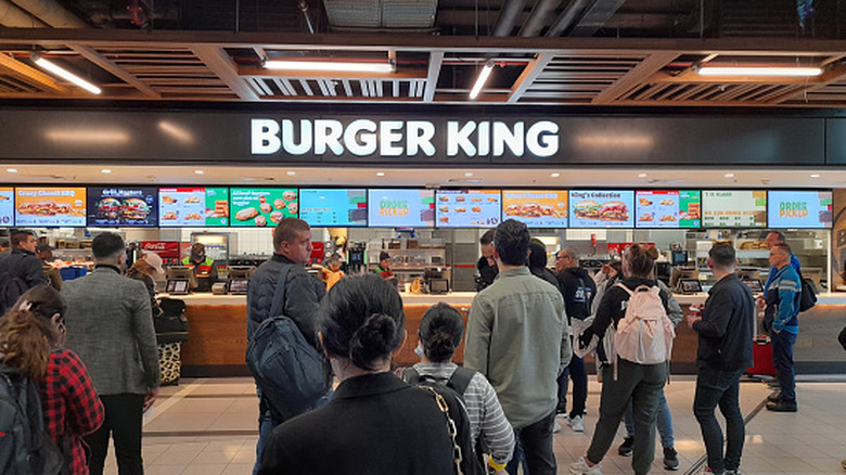Customers waiting in line at a Burger King restaurant