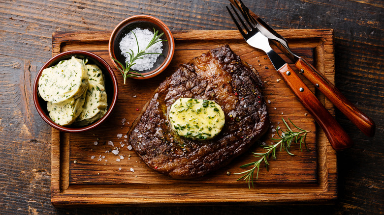 a whole steak with compound butter on top