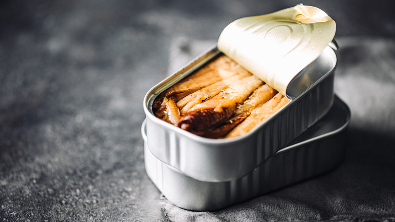 Canned fish stacked on a countertop.