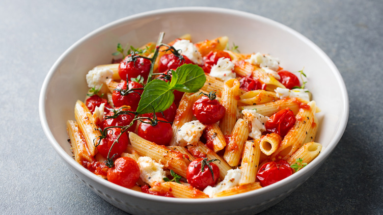 Dish of pasta with roast cherry tomatoes