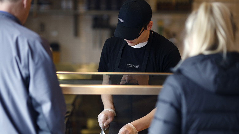 Chipotle employee preparing a meal