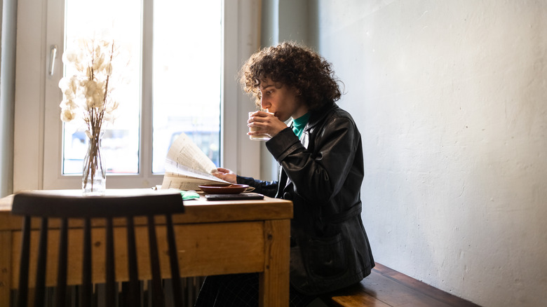 Person sipping a cup of coffee