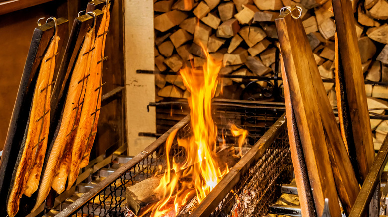 Salmon grilled on cedar planks over open flame