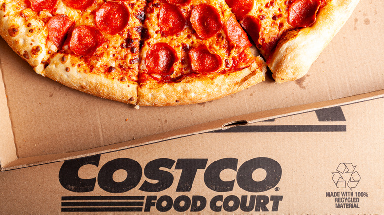 Four pepperoni pizza slices on cardboard box with Costco logo