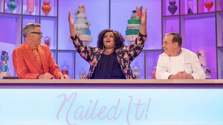 The judges of "Nailed It!" behind a desk