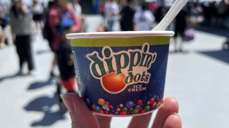 Dippin' Dots cup held by person