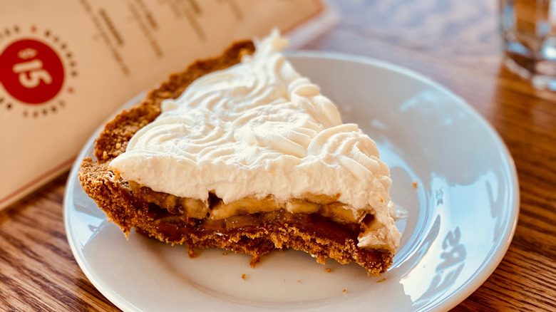 A slice of banana cream pie at a diner.