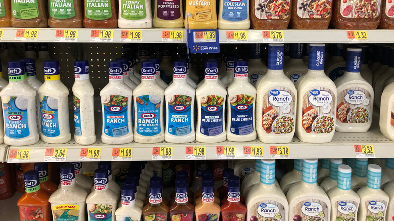 A grocery store shelf full of salad dressing including more than one brand of Ranch
