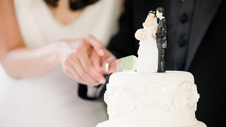 A bride cuts a wedding cake