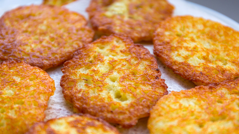 A close-up of fried hash brown patties