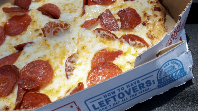 a pepperoni pizza in a domino's box
