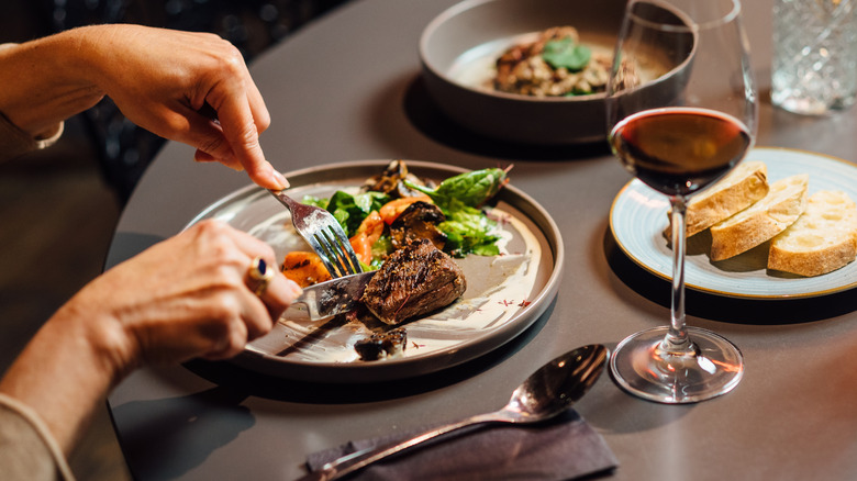 Steak cut with fork and knife