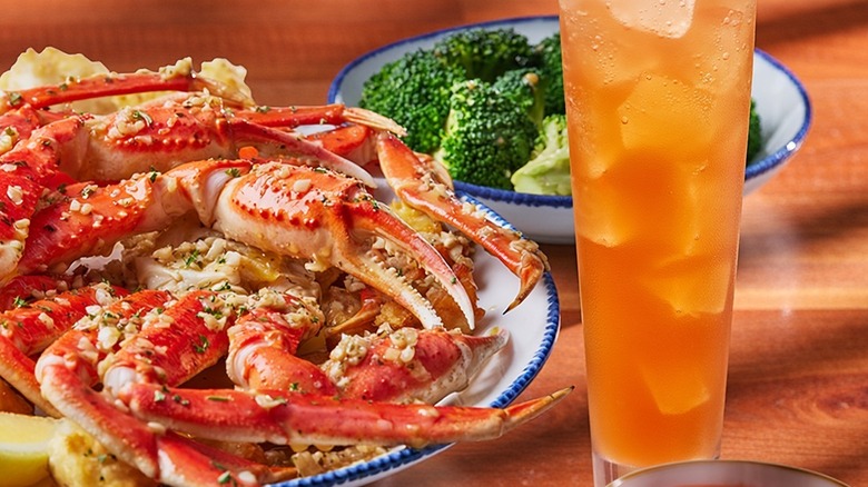 A lobster meal at restaurant chain Red Lobster, featuring broccoli and lemonade