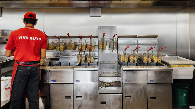 Five Guys worker preparing fries