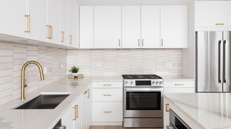A modern kitchen with white quartzite countertops