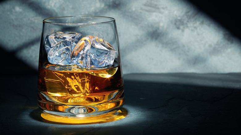 A glass of whiskey with ice
