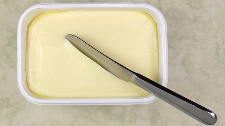 margarine tub next to a knife