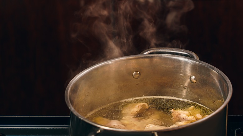 steaming pot containing bones and broth 