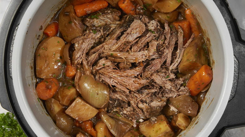 slow cooker with meat and vegetables