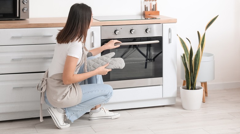 woman opening an electric oven