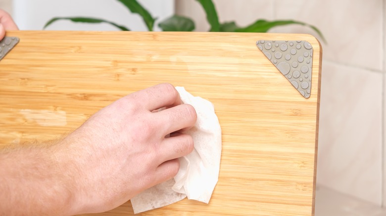 Hand wiping bamboo cutting board