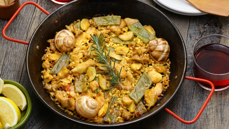 Closeup of traditional paella Valenciana with chicken in a paella pan