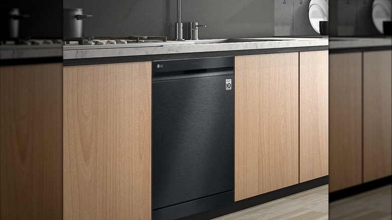 LG black dishwasher installed in kitchen with wooden cabinets