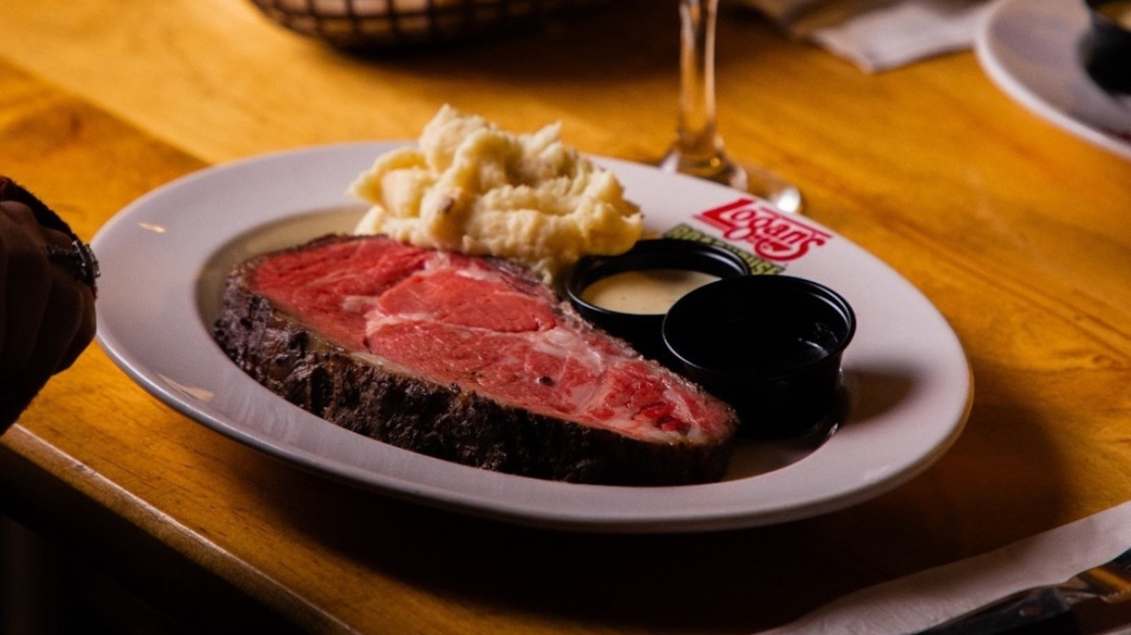 Why Logan's Roadhouse's Juicy Steaks Taste Smokier Than The Competition - Tasting Table