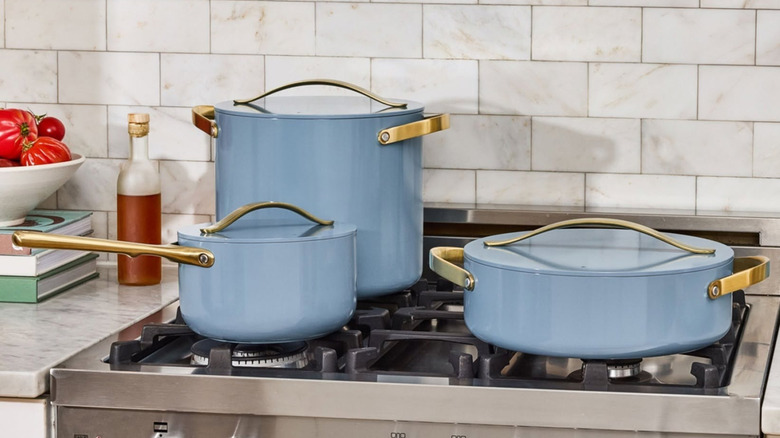 Blue Caraway brand pots and pans on a stovetop