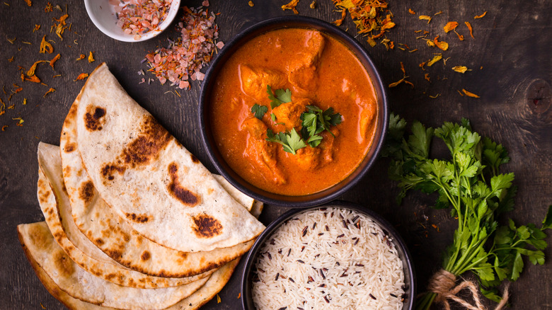 Chicken tikka masala, rice, and naan, photographed from above