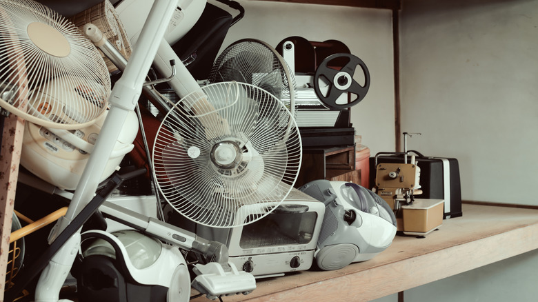An assortment of secondhand electrical appliances on a shelf