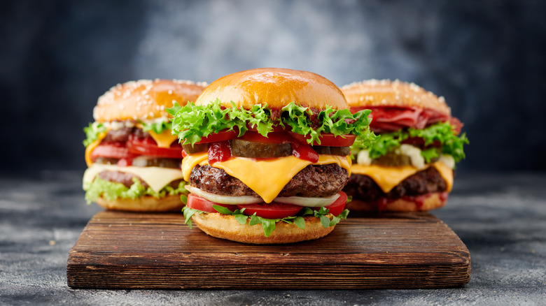 thick burgers stacked high with toppings