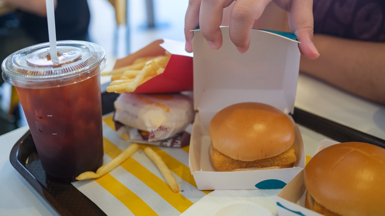 person opens box of McDonald's Filet-O-Fish sandwich
